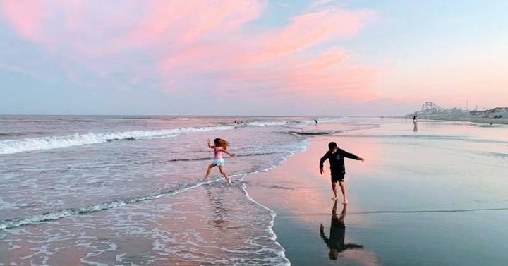 Children playing on wildwood beach at sunset